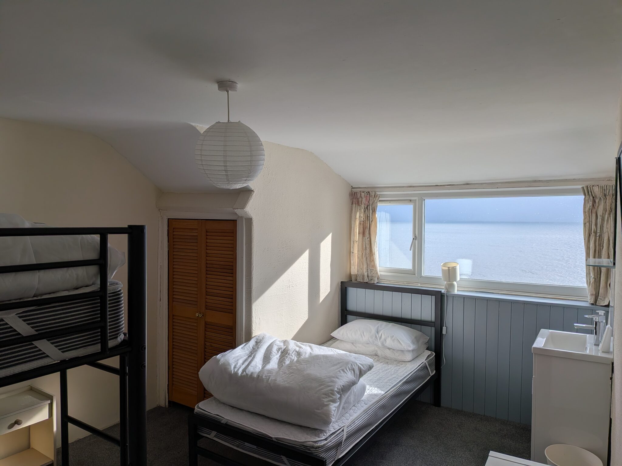 Room 10 - 3rd floor bedroom with sea views and vanity unit
